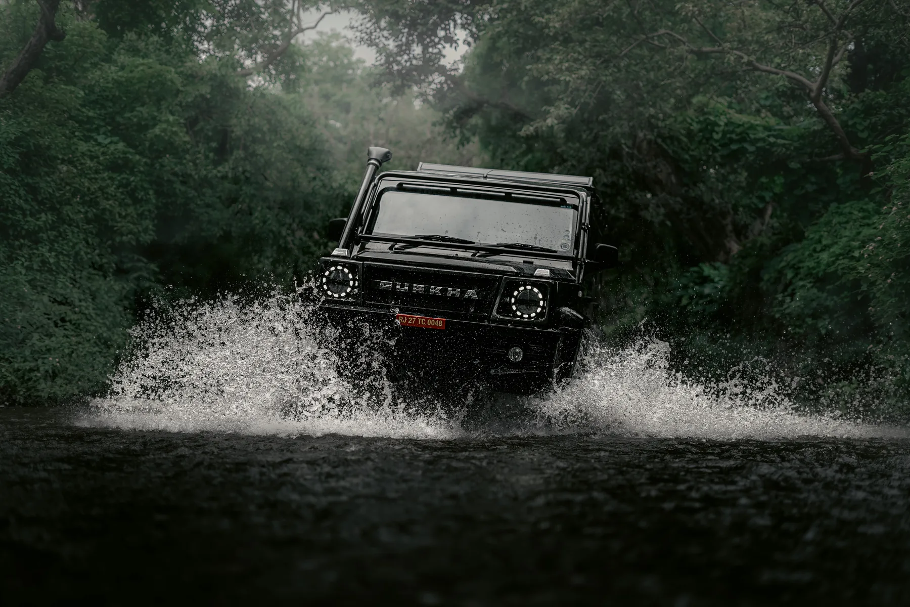 Off-road vehicle emerging from a water crossing